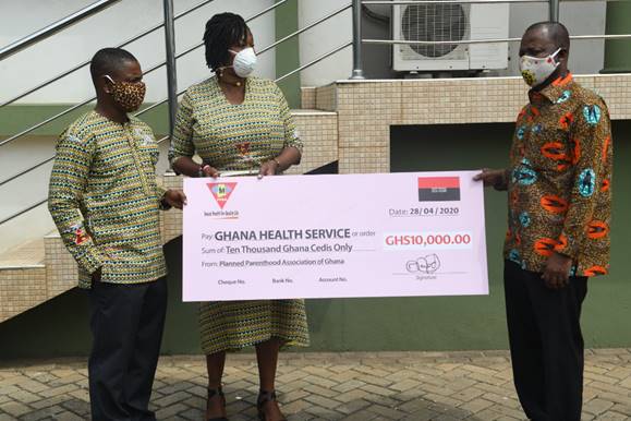 Abena Adubea Amoah (Executive Director) & Gideon Leckson-Leckey (PPAG National Treasurer) presenting the cheque to Dr. Patrick Aboagye, Director General, Ghana Health Service